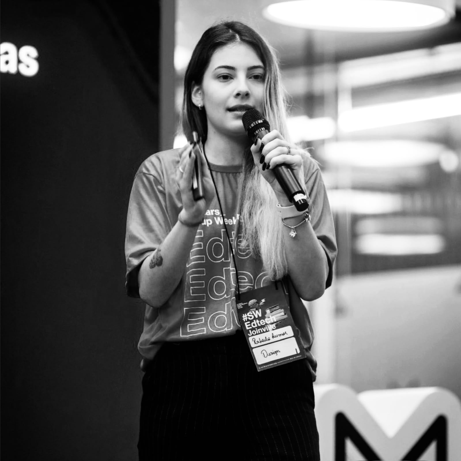Rafaela Stefany, estrategista de marketing, falando ao microfone num evento